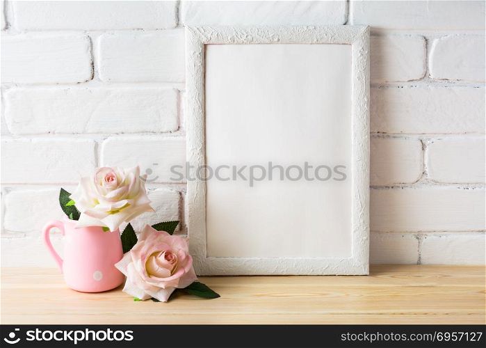 White frame mockup with white and golden vases. Empty white frame mockup for design presentation. Portrait or poster white frame mockup.. White frame mockup with two pale pink roses