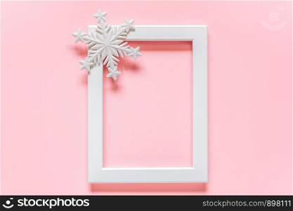 White frame with decoration snowflake on pink background with copy space. Concept Merry christmas or Happy new year. Minimal style Top view Flat lay Template for your design, card, invitation.. White frame with decoration snowflake on pink background with copy space. Concept Merry christmas or Happy new year. Minimal style Top view Flat lay Template for your design, card, invitation