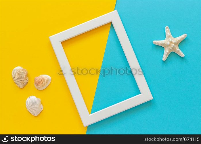 White frame with starfish on blue, yellow background and seashells. Creative Flat lay Top view Template for postcard, design Copy space for text.. White frame with starfish on blue, yellow background and seashells. Creative Flat lay Top view Template for postcard, design Copy space for text