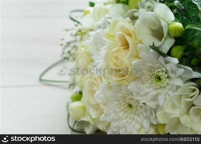 white fresh roses, freesia and mum flowers bouquet close up. white bouquet