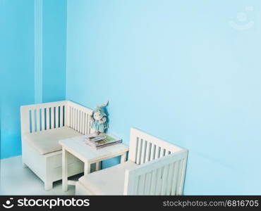 White furniture in a light blue room corner