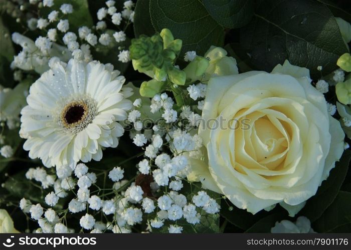 white gerbera, white roses and white gypsophila in a wedding arrangement