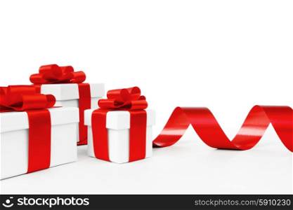 White gift boxes tied with a red satin ribbon bow isolated on white background