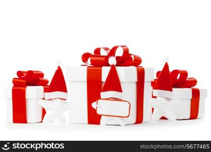 White gift boxes with red ribbons, stars with santa claus hats isolated on white background