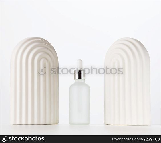 white glass bottle with a pipette on a white background. Template for cosmetic liquid products, advertising and promotion
