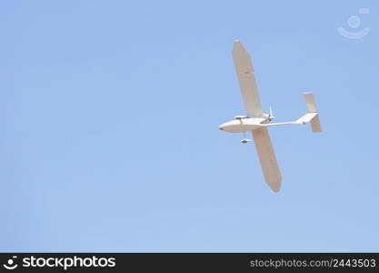 White glider plane in the blue sky. White glider plane in blue sky