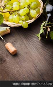 White grapes, corkscrew, cork and bottle with copyspace