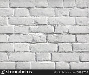 White grunge brick wall background. White grunge background of old brick wall texture with delicate vignetting.