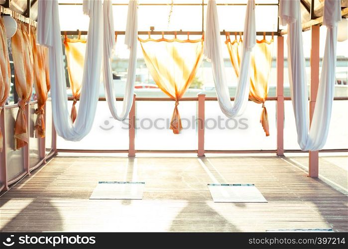 White hammocks in an empty yoga flight hall. Healthy and fly Yoga Concept