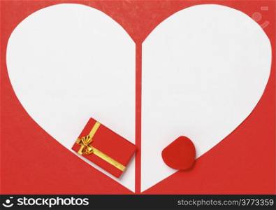 White heart paper on red background with two gift boxes. Valentine&rsquo;s Day or holiday greeting card. Heart symbol frame.