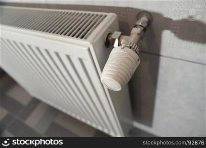 white heating radiator under in the room
