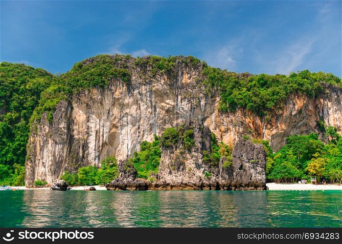 white high steep cliff and beautiful beach of the island of Hong in Thailand - view from the sea