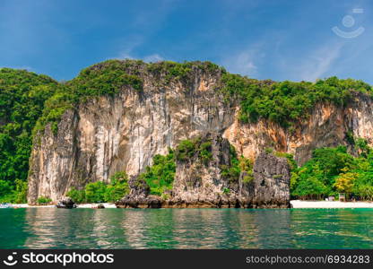 white high steep cliff and beautiful beach of the island of Hong in Thailand - view from the sea