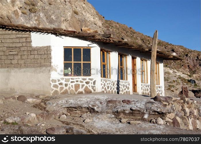 White house near the mount in desert near Uyuni in Bolivia