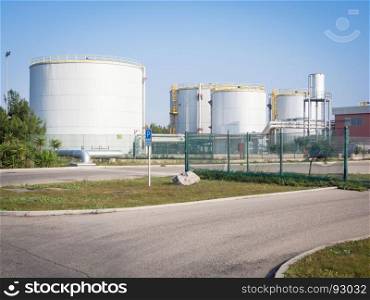 white industrial tanks in the industrial port of Oristano