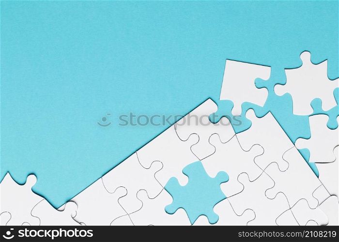 white jigsaw puzzle piece blue backdrop