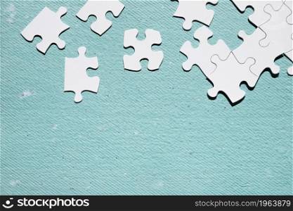 white jigsaw puzzle piece blue textured surface. High resolution photo. white jigsaw puzzle piece blue textured surface. High quality photo