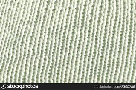 White knitted fabric texture. Wool sweater background.