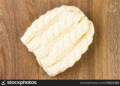 white knitting cap on wooden background