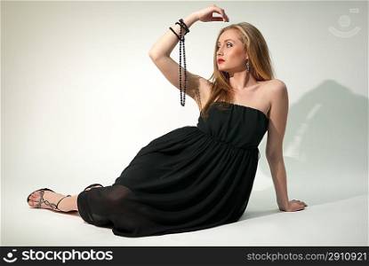 White lady in black chiffon dress with beads