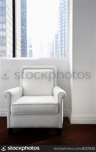 White Leather Chair Sitting and a Window