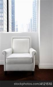White Leather Chair Sitting and a Window