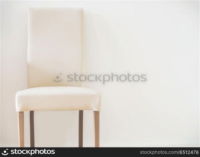 White leather stool and copy space on the wall. Simple interior