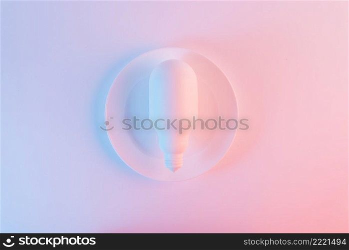white light bulb plate against blue pink background