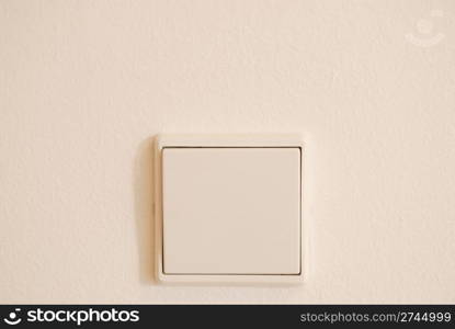 white light switch against white wall (plenty copy-space)