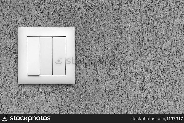 White light switches over a grey wall. Horizontal