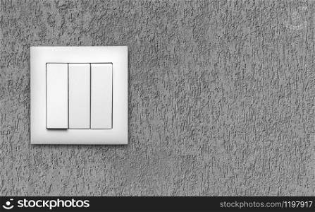 White light switches over a grey wall. Horizontal