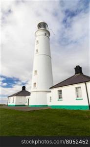 White lighthouse and associated buildings. Nash Point, Vale of Glamorgan, Wales.