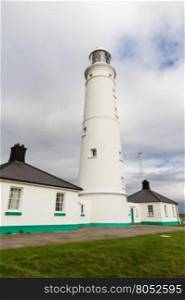 White lighthouse and associated buildings. Nash Point, Vale of Glamorgan, Wales.