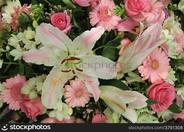 white lilies and pink gerberas and roses in a bridal flower arrangement