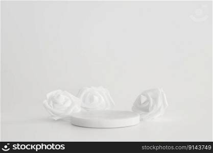 White marble podium on the white background with flowers. Podium for product, cosmetic presentation. Creative mock up. Pedestal or platform for beauty products. White marble podium on the white background with flowers. Podium for product, cosmetic presentation. Creative mock up. Pedestal or platform for beauty products.