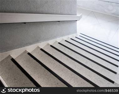 White marble staircase with the metal rail in the office building.