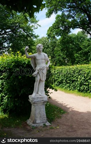 White marble statue in a summer park