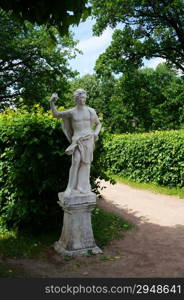 White marble statue in a summer park