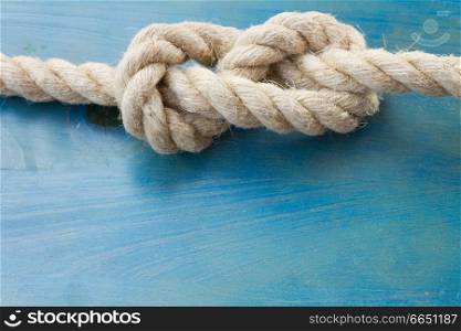 white marine knot on blue wooden background with copy space. marine knot