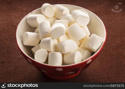 White marshmallows close up in a bowl. marshmallows in a bowl