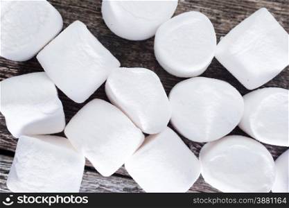 white marshmallows on the wooden table, fresh and sweet marshmallows