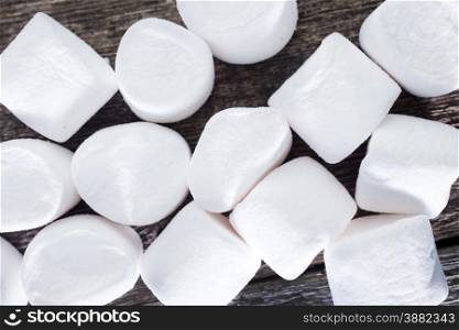 white marshmallows on the wooden table, fresh and sweet marshmallows