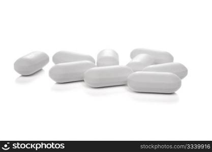 white medical tablets over white