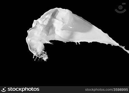 White milk splash isolated on black background