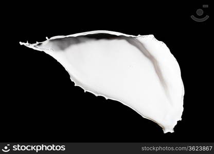 White milk splash isolated on black background