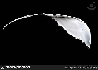 White milk splash isolated on black background