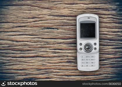 White mobile smart phones on wooden background.