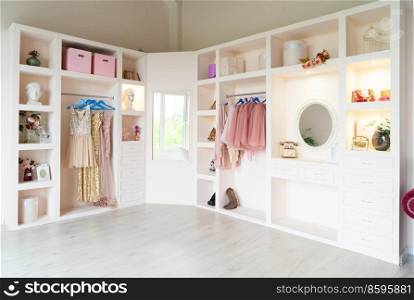 white modern wardrobe with stylish female clothes. wardrobe with clothes