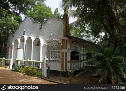 White mosque and palm tree in Kataragama, Sri Lanka