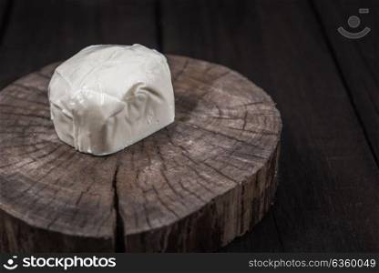 white mozzarella cheese on a wooden end of a tree
